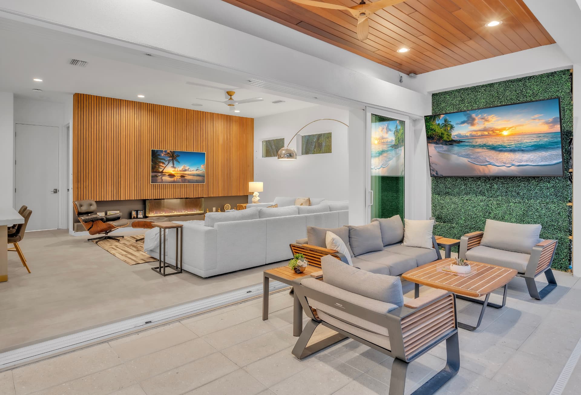 Contemporary living area with a timber ceiling, wood feature wall, and pale lounge seating