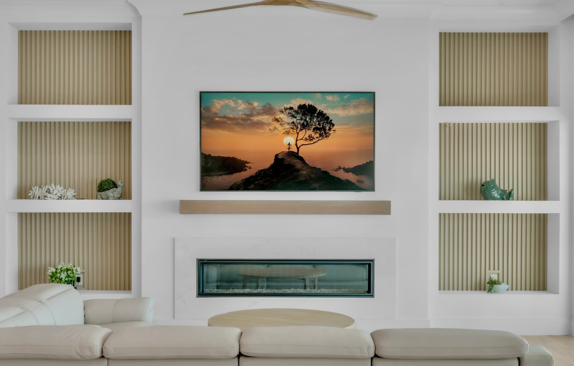 Living-room detail with built-in shelving, a curved sofa, and wood paneling